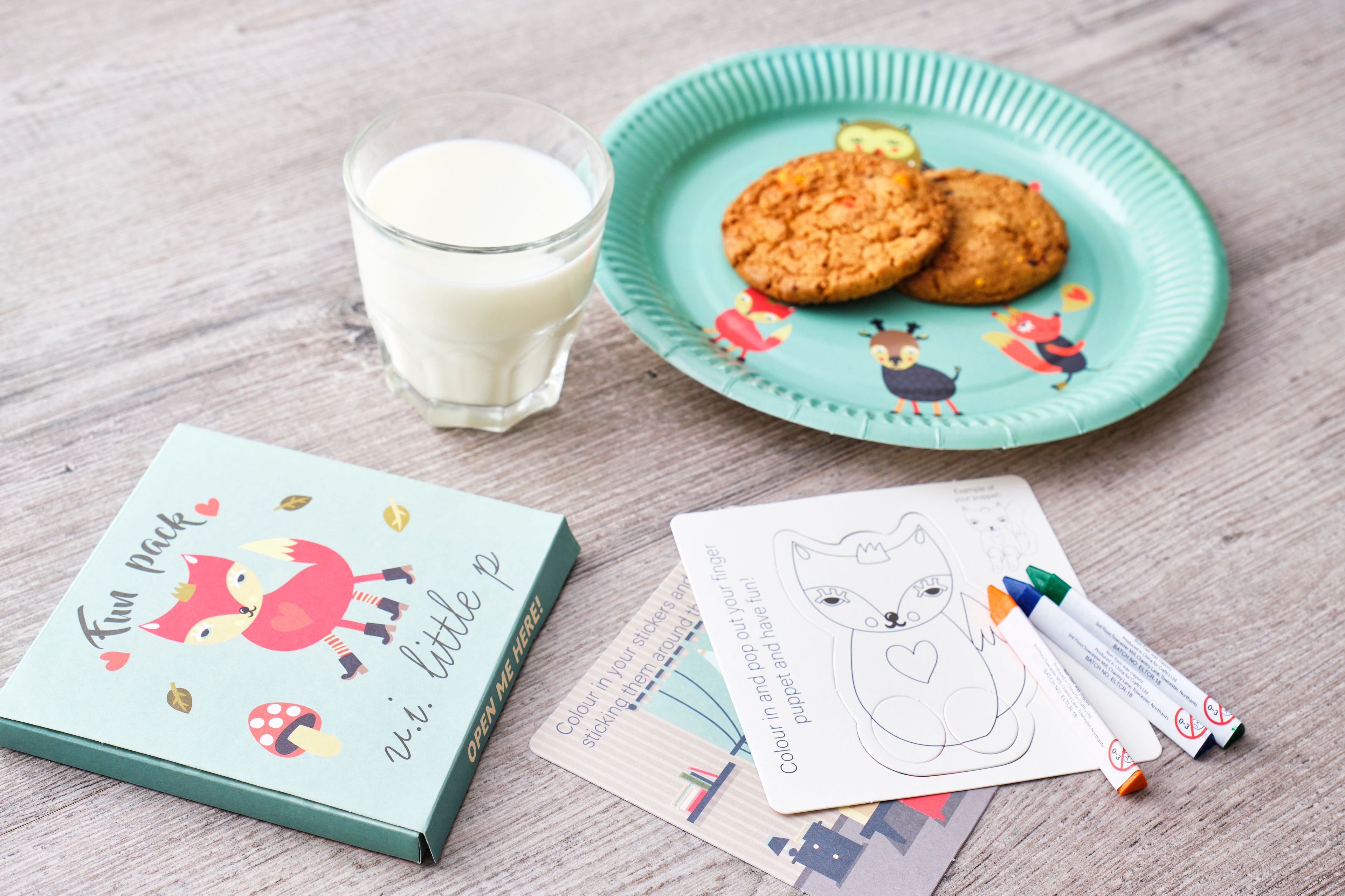 fun pack with coloring page, crayons, plate of cookies, and milk