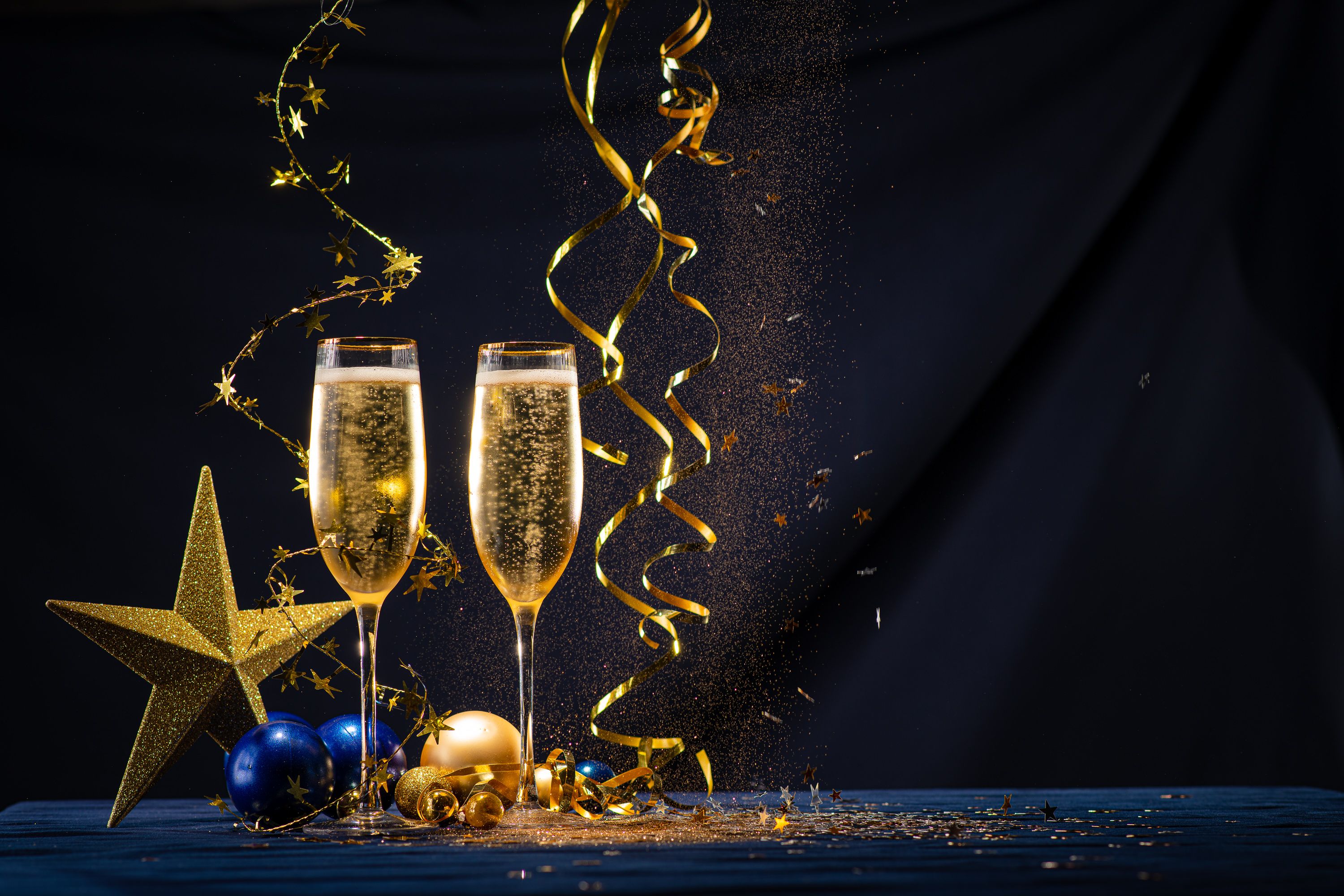 two glasses of champagne with decorations and streamers