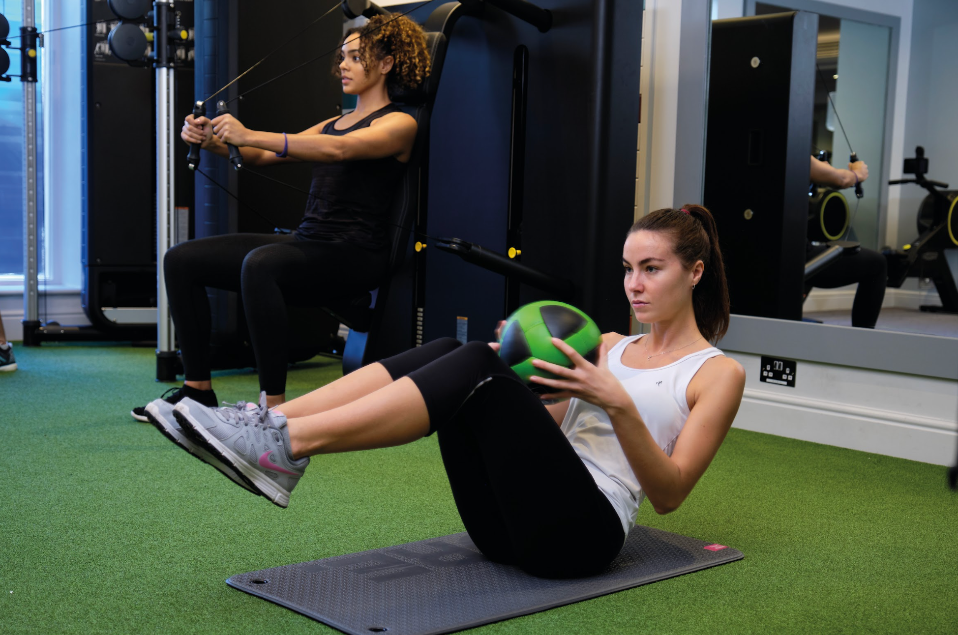 two women exercising in the gym