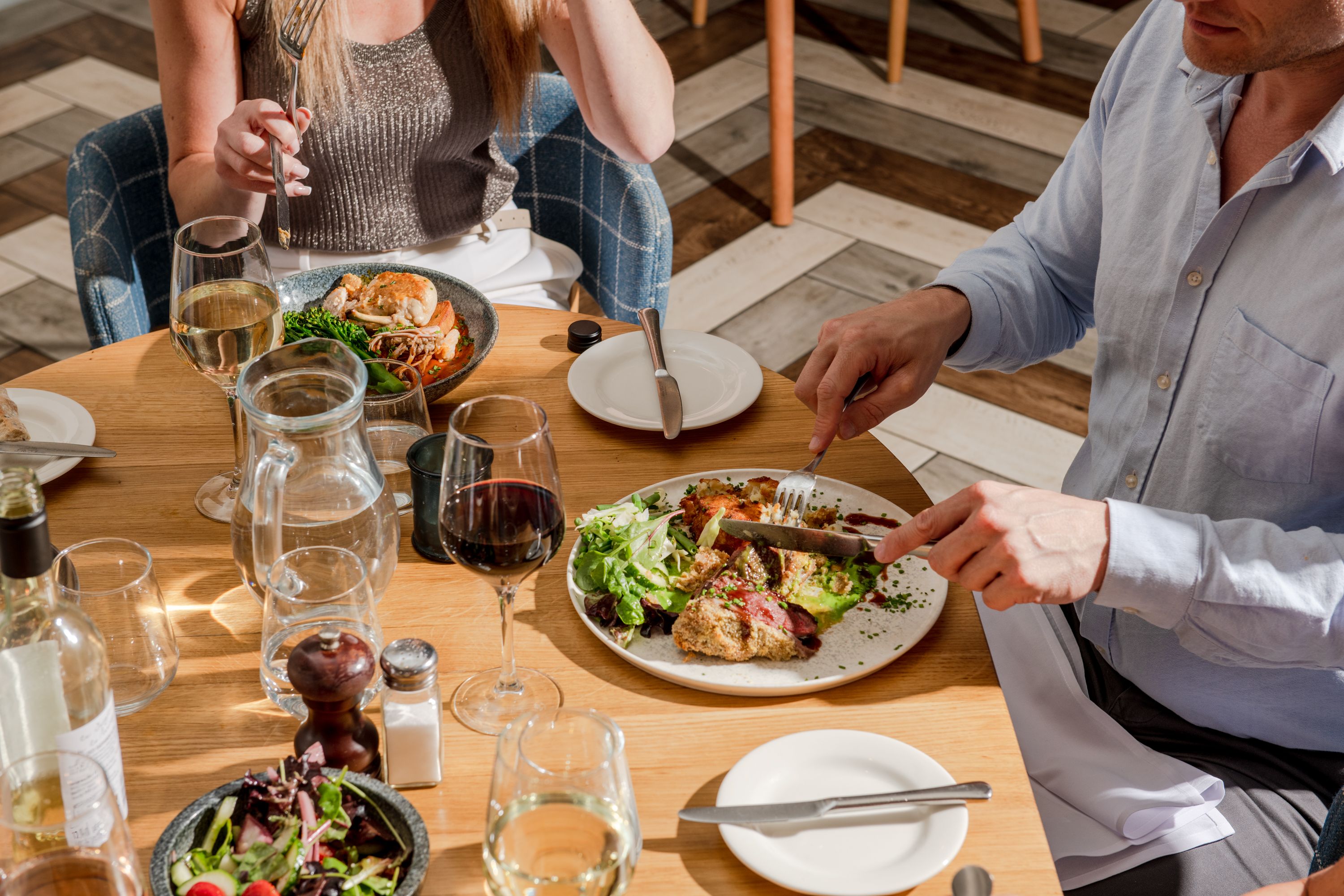 a group of people eating and drinking at a table