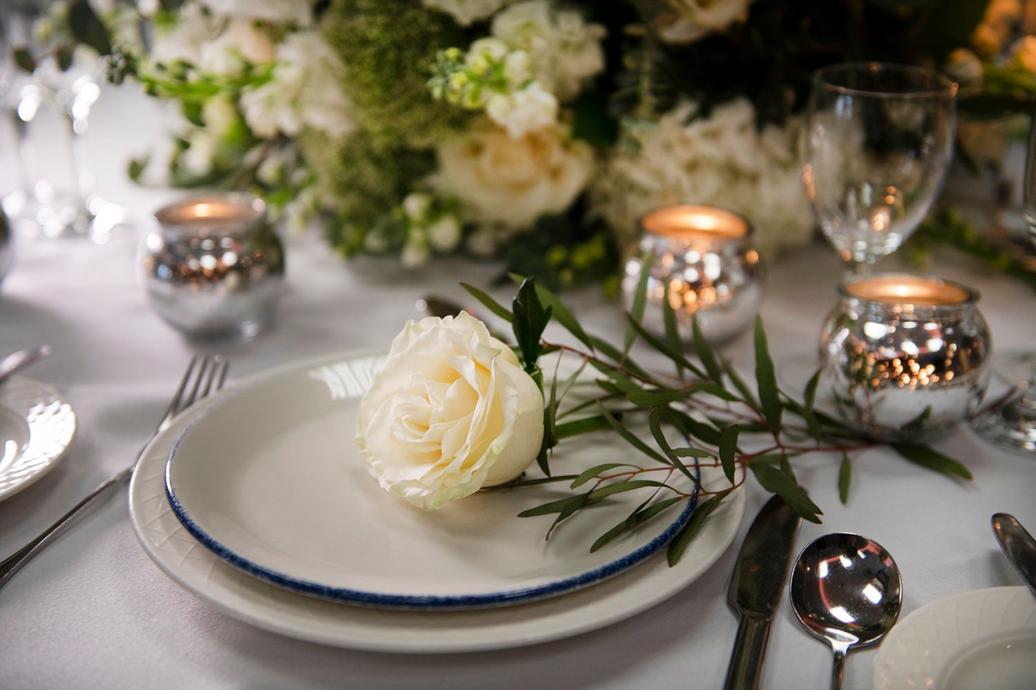 elegant table setting with white rose and candles