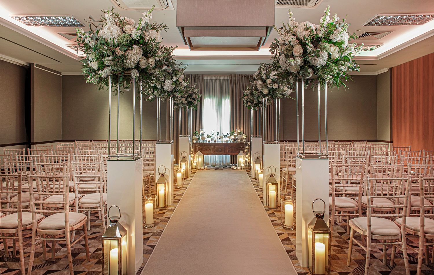 wedding aisle with floral arrangements and candles