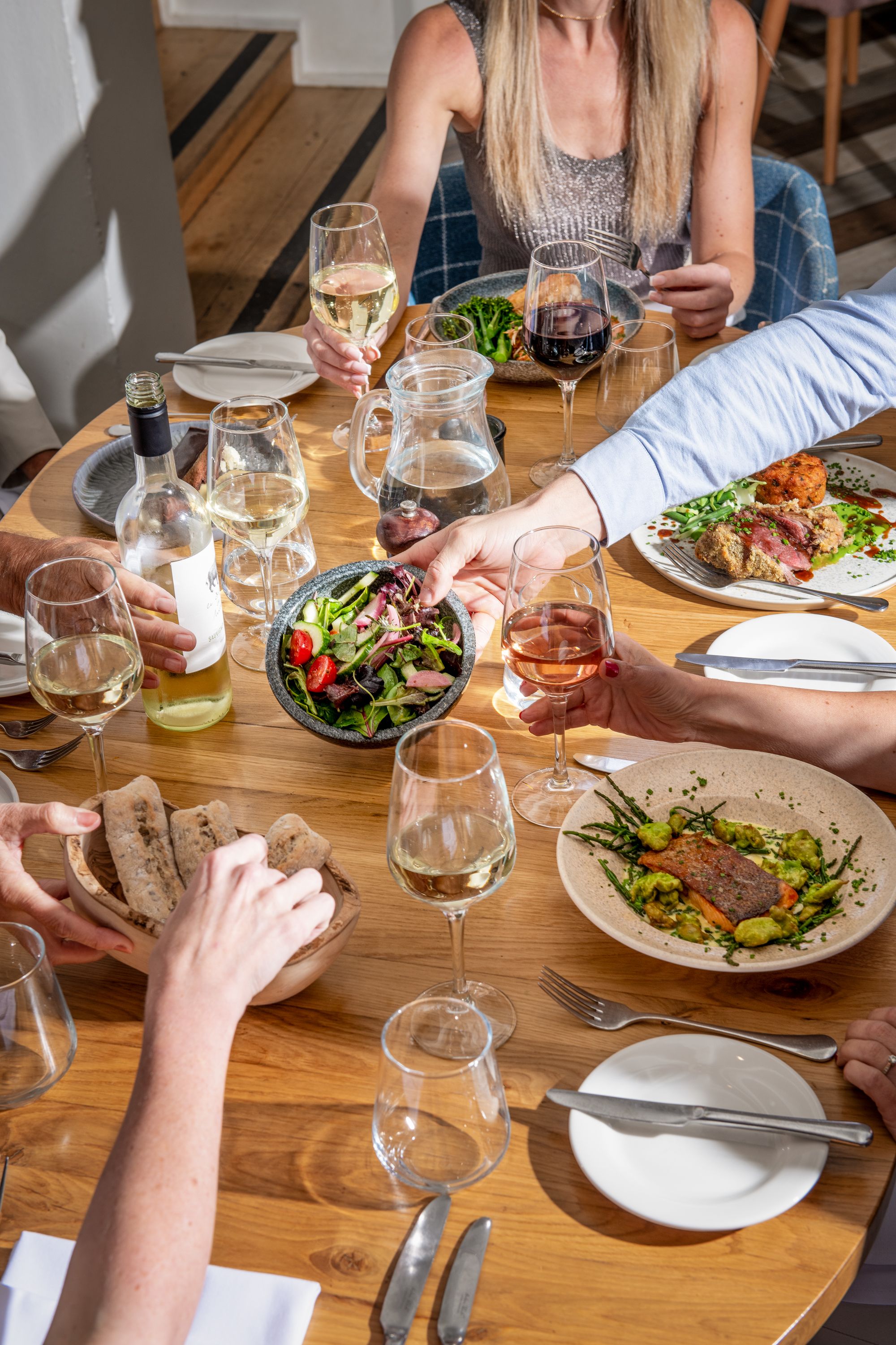 a group of people eating and drinking at a table