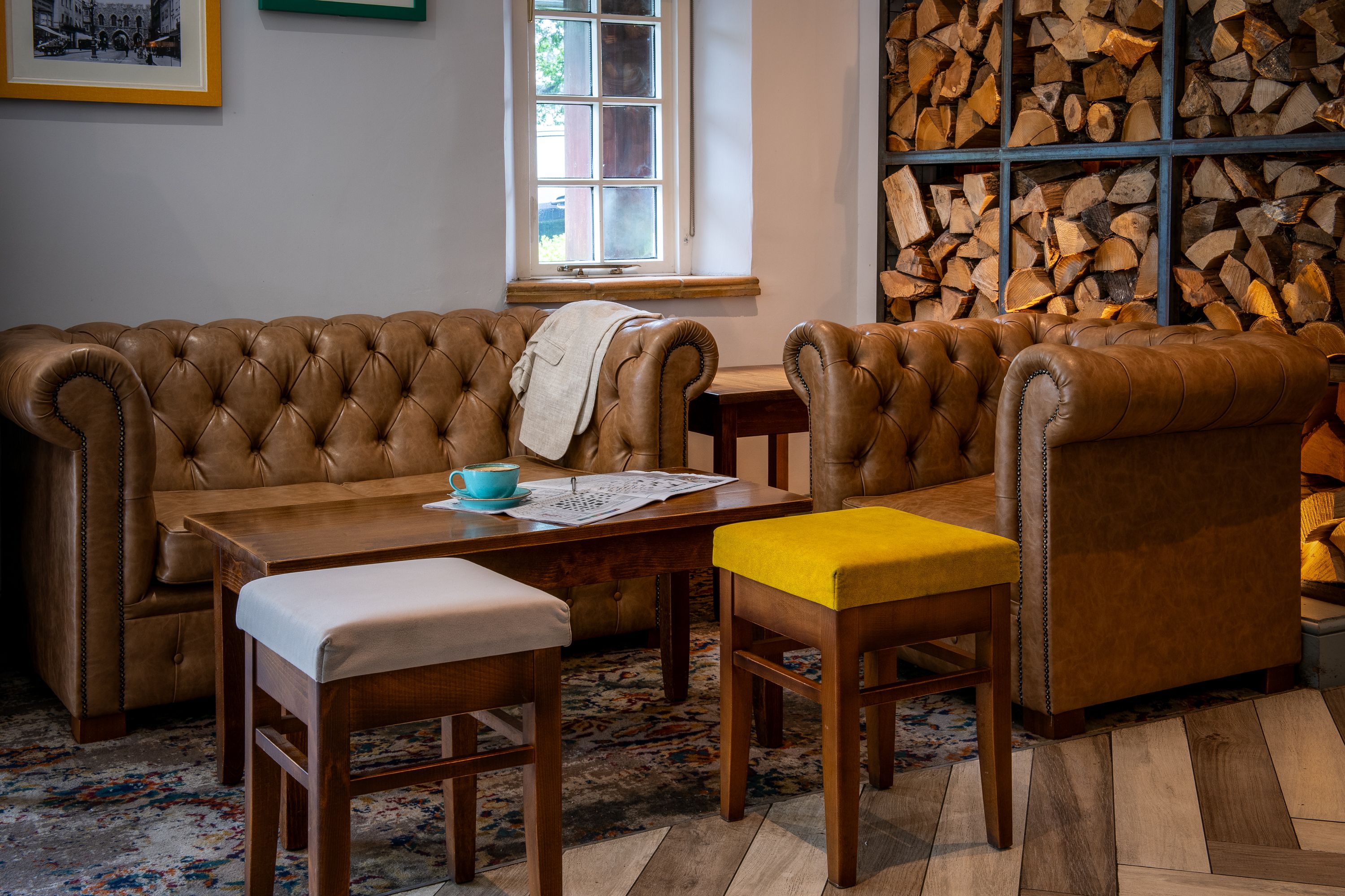 room with leather sofas and wood accents