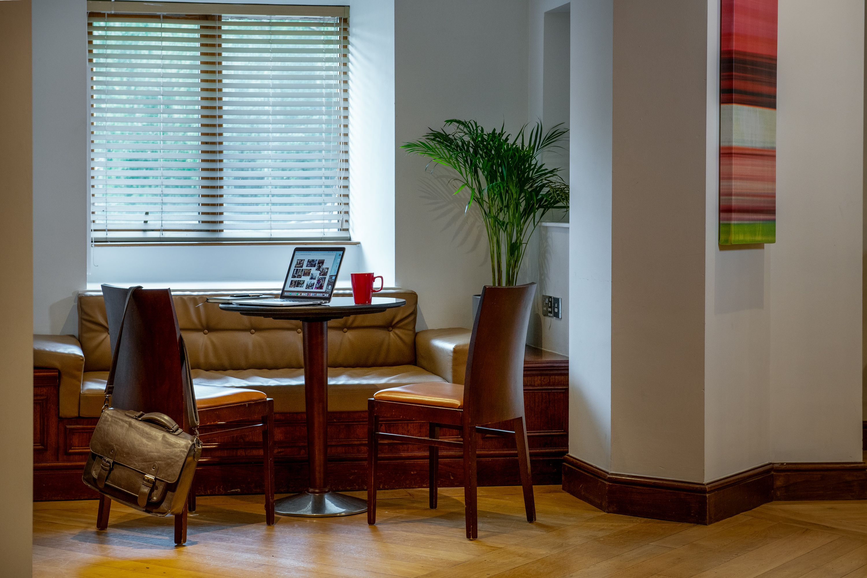 hotel room with couch, table, and chairs