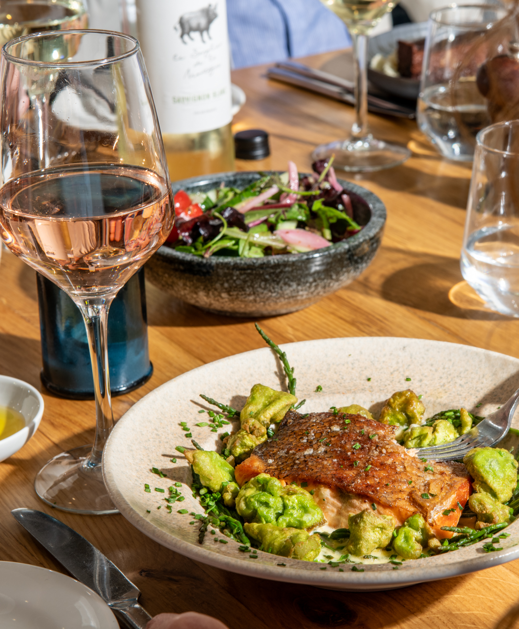 Salmon dish with glass of rose